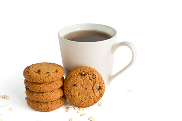 Crunchy oatmeal cookies and a mug of black tea isolated on a white background. tea party. Copy of the space. The view from the top