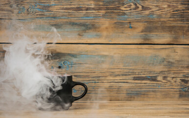 hot coffee cup and smoke on wooden dark background