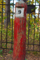 the number nine painted to a post, aged worn look