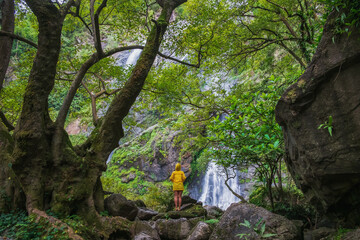 Beautiful waterfall with one person standing looking.