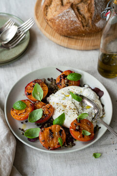 Table setting with Fresh salad with Roasted Peaches and Burrata