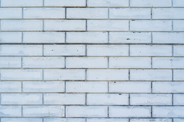 White brick wall with cracked paint. Brick background