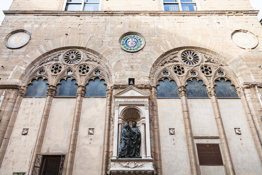 FLORENCE, ITALY - NOVEMBER 4, 2016: facade of Orsanmichele church with statue Christ and St Thomas. Church was originally built as a grain market in 1337 on the site of kitchen garden of monastery