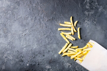 French fries over dark texture background