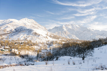 Fototapeta na wymiar Winter beautiful mountain landscape of the Tianshan mountain system in Uzbekistan on a clear Sunny day