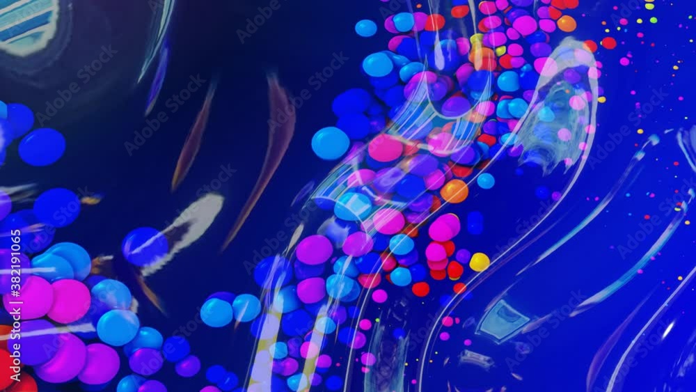 Poster abstract looped background of shiny glossy surface like wavy blue liquid with rainbow color circles 