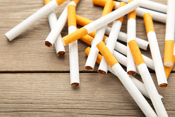 Cigarettes on grey wooden background. Top view.