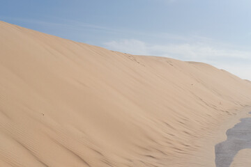 Beautiful beach landscape. Blue sky. Dune. White sand. Horizon. Sunny day. Empty nature. 
