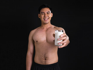 Asian muscular man with shirtless drinking milk
