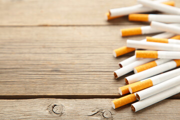 Cigarettes on grey wooden background. Top view.