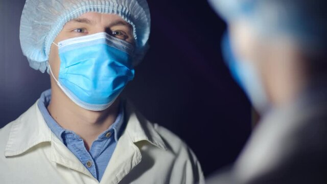 Young doctor attunes himself to the positive by looking in the mirror