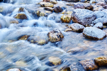 water flow in a rocky mountain stream blurred in motion
