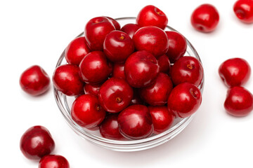 fresh black cherries in a glass plate on a white background