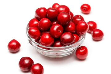 fresh black cherries in a glass plate on a white background