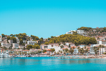 Fototapeta na wymiar Port of Sóller with houses, pine trees and water