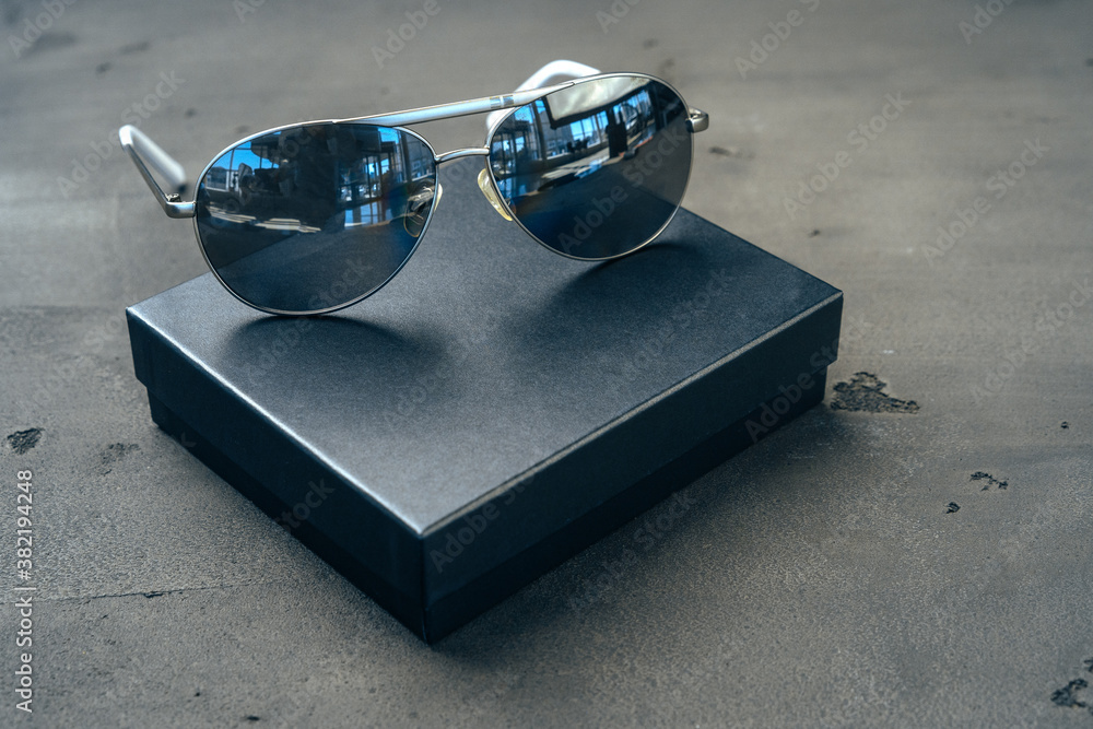 Wall mural New dark aviator glasses on grey concrete background