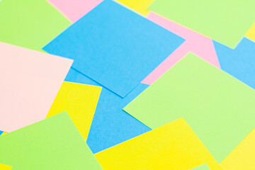 A set of office work related rainbow colored paper sticky notes. Isolated on cork background.