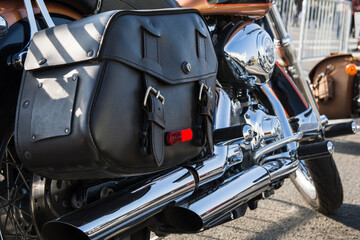 Rear part of the classic motorcycle with saddlebagsm made of black genuine leather and lots of...