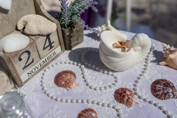 Close up view of wedding rings in the white ceramic shell on the table with wedding decor at the beach wedding ceremony, Punta Cana, Dominican Republic
