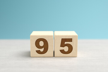 Wooden toy blocks forming the number 95.