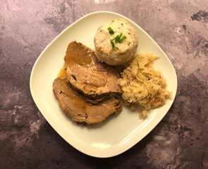Classic dish. Tender and juicy pork loin roast with gravy, Sauerkraut and bread dumpling.