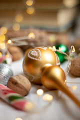 The atmosphere of Christmas and New Year. Decoration for the Christmas tree on the background of garland lights