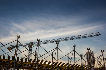 Construction site of shopping mall with cranes on a background of blue sky with cirrus clouds. Kyiv. Obolon