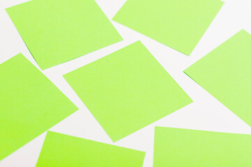 Sheets of olive-colored paper on a white background.