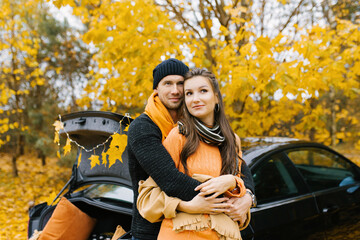 Fototapeta na wymiar Beautiful portrait of a young couple in the autumn forest