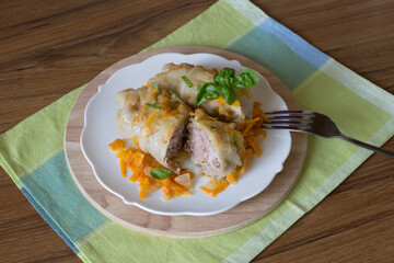 Meat stuffed cabbage leaves on a white plate, close-up