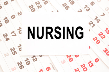 text NURSING on a sheet from Notepad.a digital background. business concept . business and Finance.