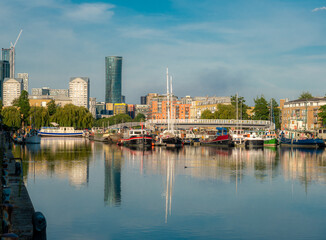 Obraz premium Surrey Docks harbour in the city of London reflected in the Thames river