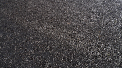 A road paved with tar, asphalt road made of small pebble stones,