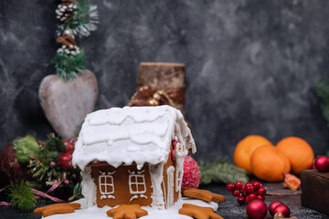 Various christmas gingerbread cookies on dark table with flour