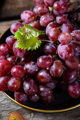 Pink grape on wooden table on wooden background. Vine grape. Still life of food.