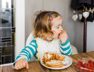 Toddler girl favoring pastries over fruit