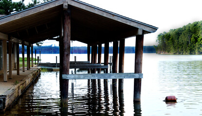 Old boat dock on peaceful lake.