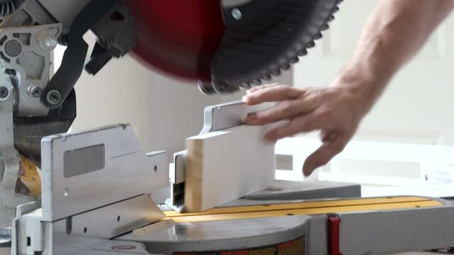 Cutting wooden trim board on with circular saw works on remodeling home