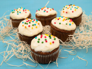 Carrot muffins with cream cheese frosting and sprinkles