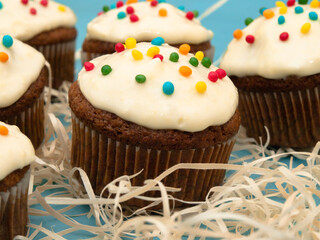 Carrot muffins with cream cheese frosting and sprinkles