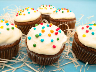 Carrot muffins with cream cheese frosting and sprinkles