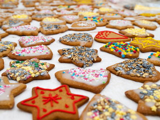 Christmas gingerbread cookies with icing and colorful sprinkles