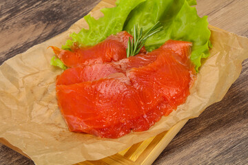 Sliced salmon fillet served rosemary