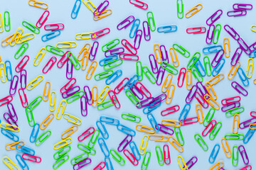 Paper color clip notebook on blue background. Flat lay.