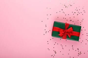 Obraz premium Gift or present box and stars confetti on color table top view. Flat lay composition for birthday, mother day or wedding.
