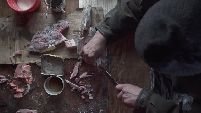 Chukchi cuts frozen fish in winter