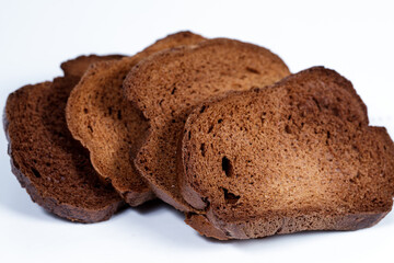 The texture of toasted pieces of bread. Croutons on a white background. Dark dry bread.