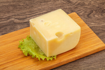Emmental cheese over wooden board