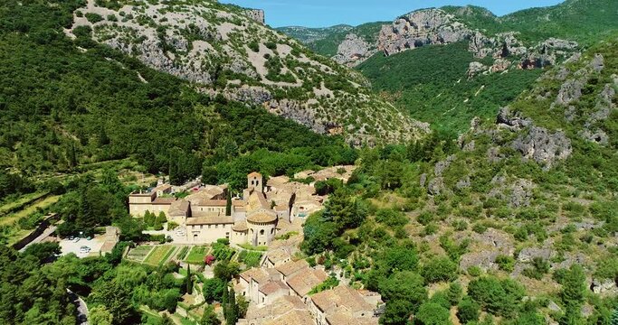 Beautiful village of Saint Guilhem Le D&eacute;sert a traditional village in France in the middle of mountains 4K aerial view with a drone