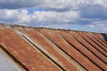 Old roof made of metal sheets with rust